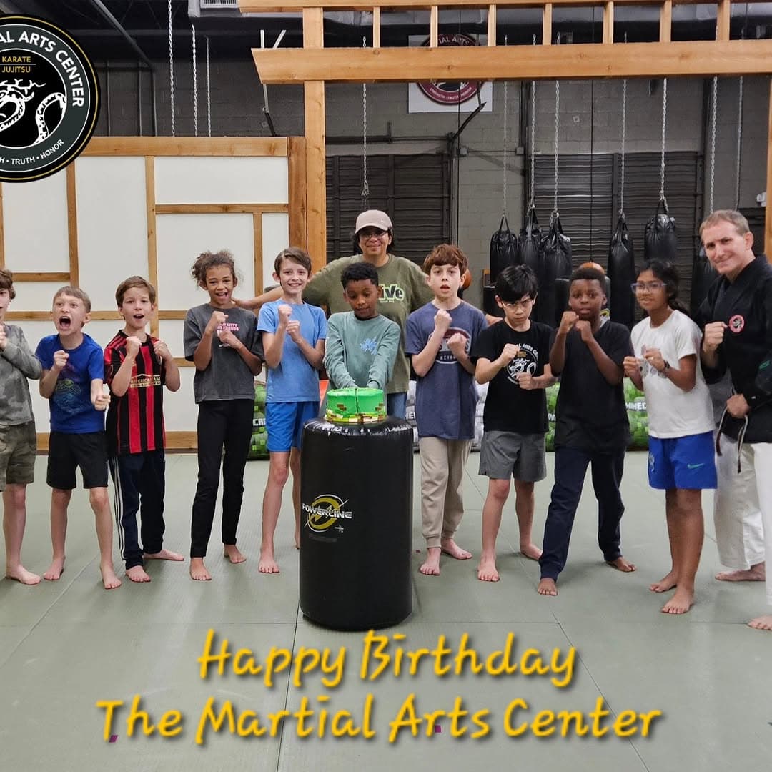 Karate birthday party around a decorated heavy bag