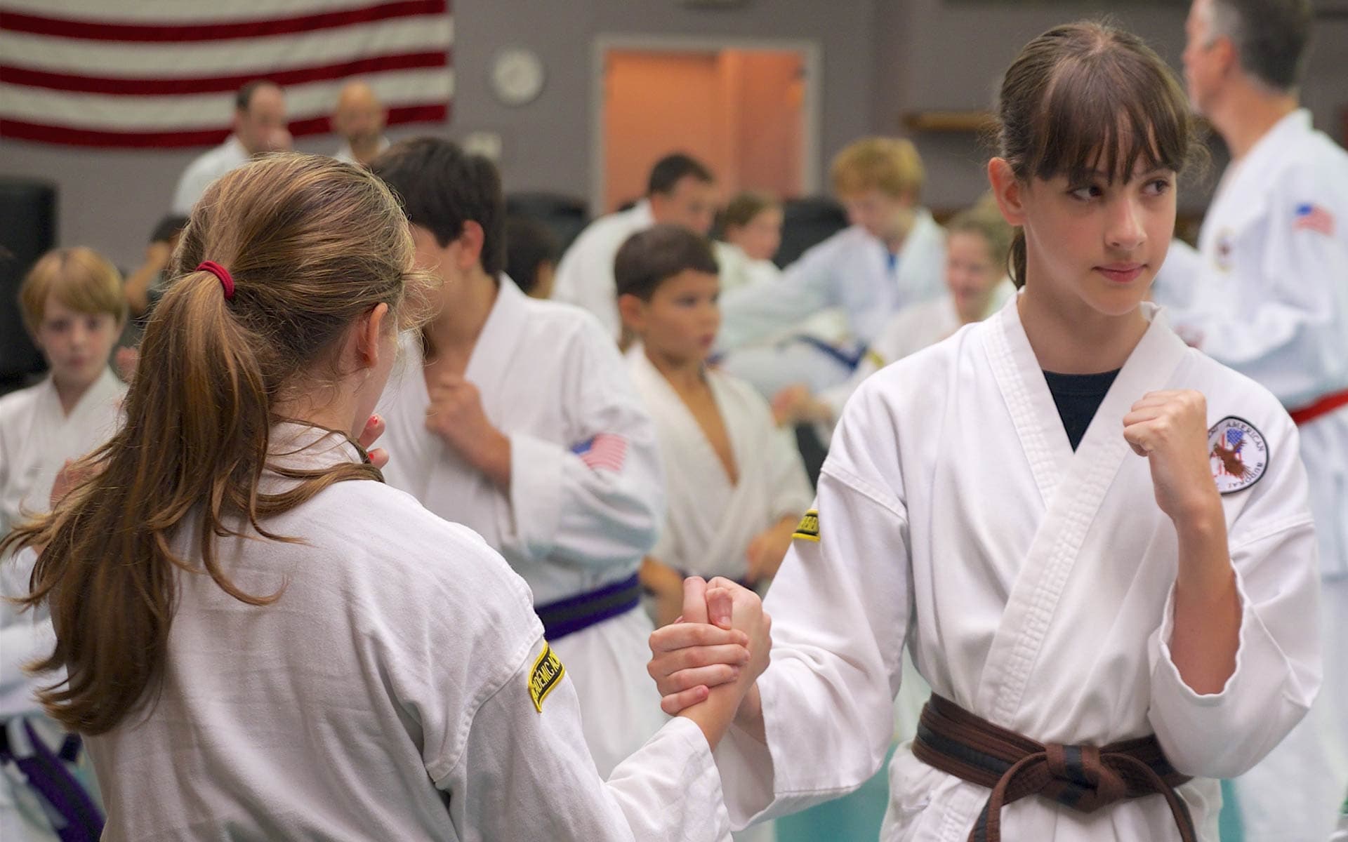 Two students fist-bumping in front of the class