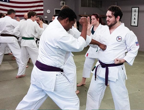 Two adult students working a self-defense technique