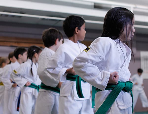 Young Dragon class students lined up at attention